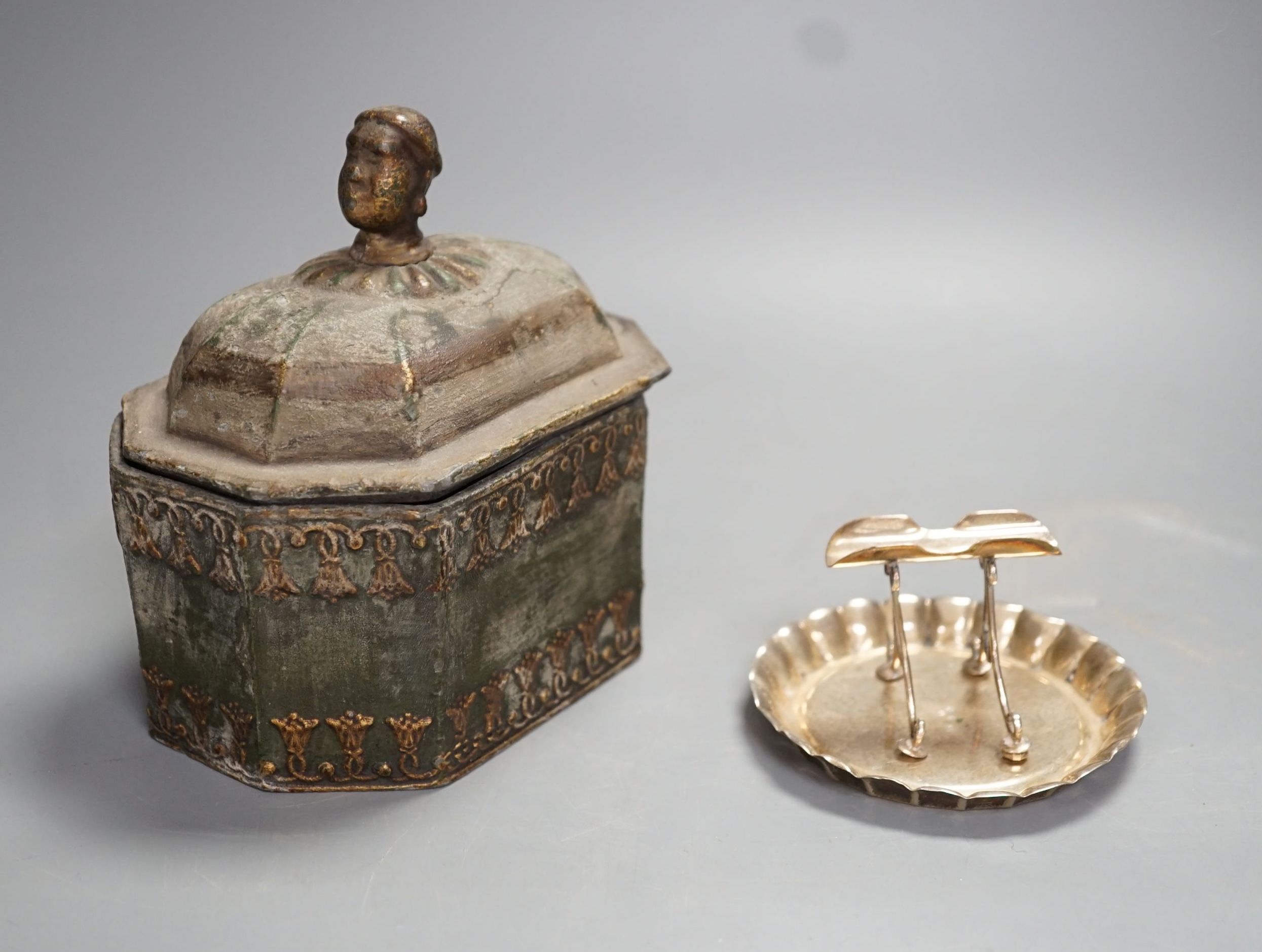 A Regency octagonal lead tobacco box, weight and cover, with slave-head finial, 14cm tall, and late Victorian silver cigarette holder